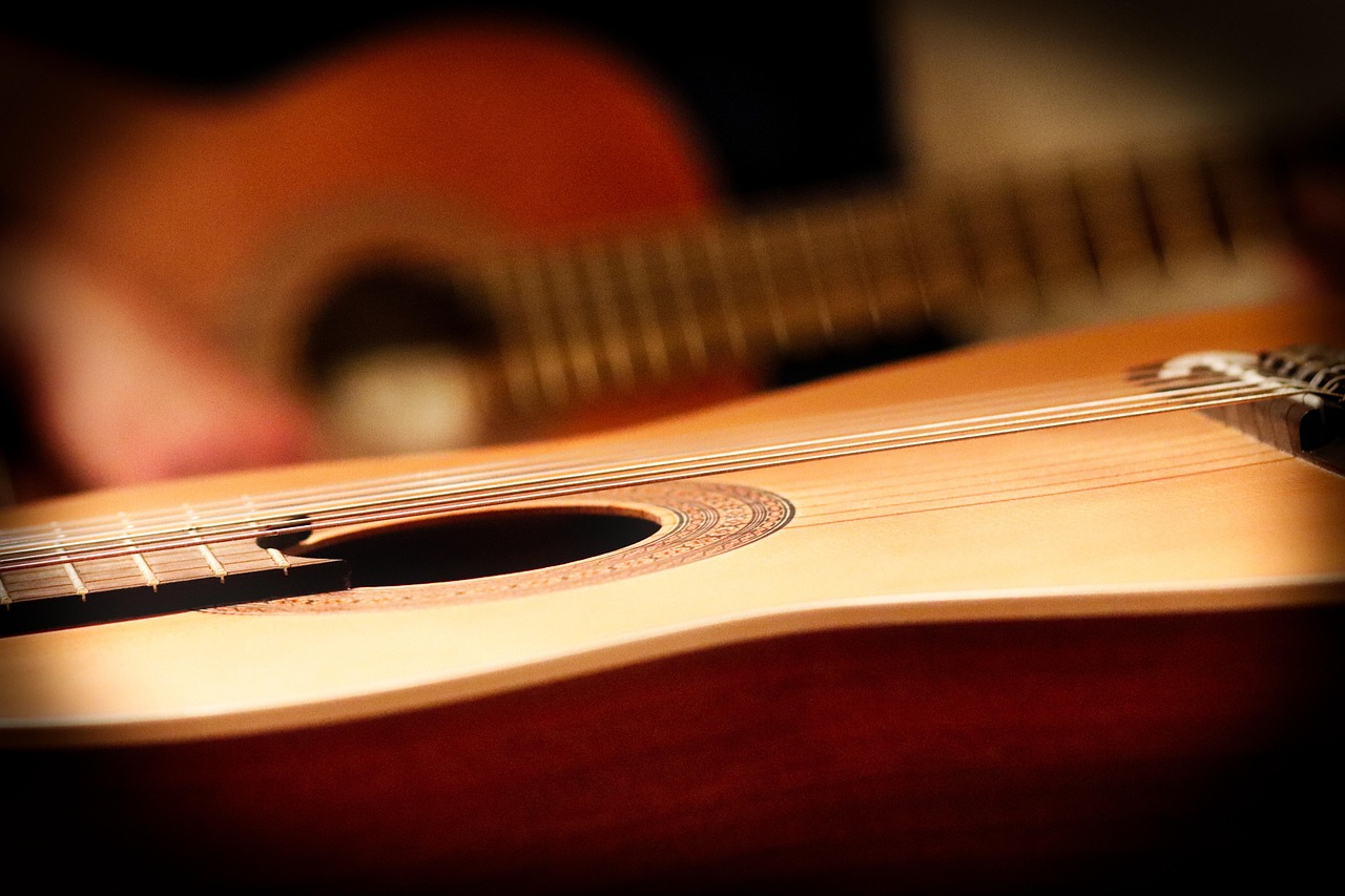 guitar teacher teaching adult student